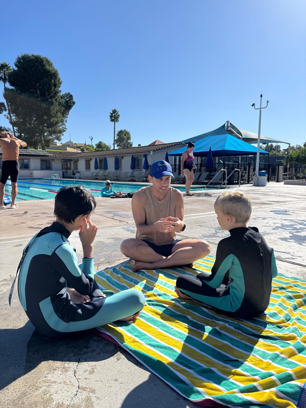 Joshua teaching two kids at the pool